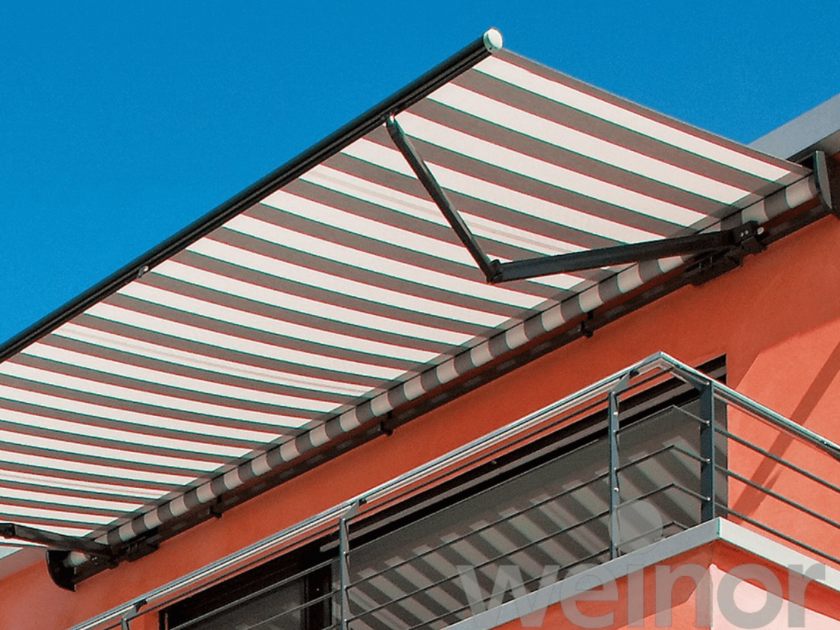 Stripped fabric weinor Topas open cassette canopy, providing welcome shade on a balcony