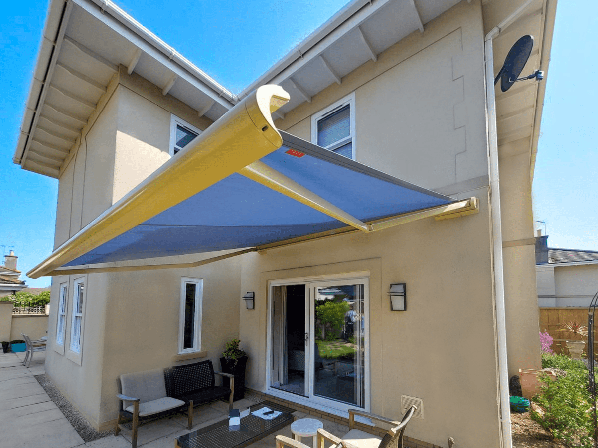 weinor Cassita ll patio awning, with blue fabric in a vibrant yellow cassette