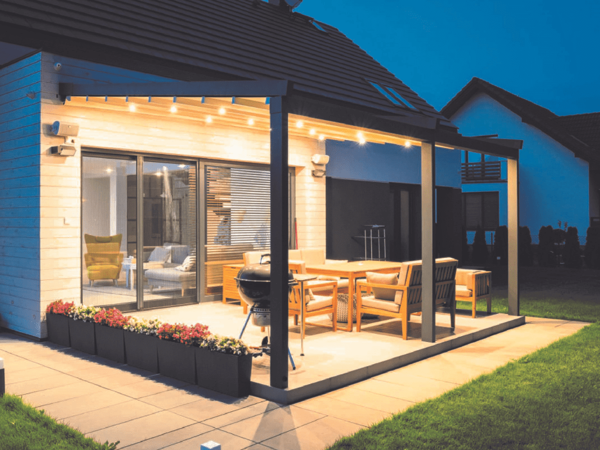 Tarasola Elegancy aluminium pergola with LED lights, housing a BBQ and outdoor living room