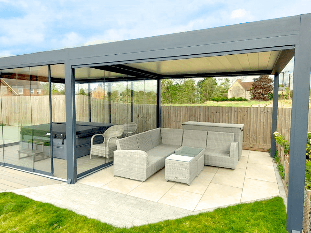 Two freestanding Tarasola Technic's fitted side by side. One to house an outdoor dining and living area, and the other to cover a hot tub. Glass sides fitted with glass sliding doors.