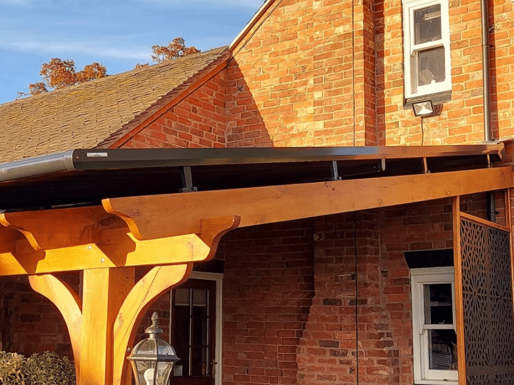 The Weinor Optistretch overawning fitted over a wooden pergola in Nuneaton, Warwickshire, provides the perfect solution to transform your outdoor space, with its high-quality and robust design, electric operation, and exceptional installation experience, exceeding all expectations.