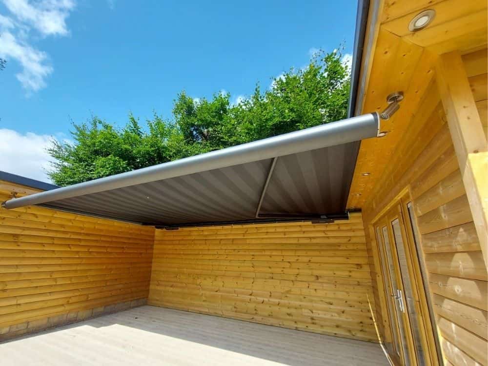 retractable patio canopy fitted between building and garage for socialising, Oxford