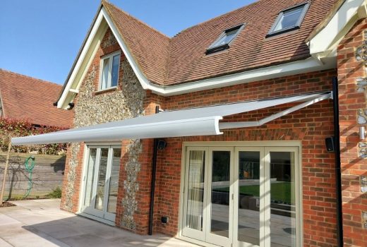 The Markilux MX-3 awning installed over a patio in Watlington provides a comfortable and convenient outdoor living space with its remote control and wind sensor, allowing for easy operation and protection from the elements.