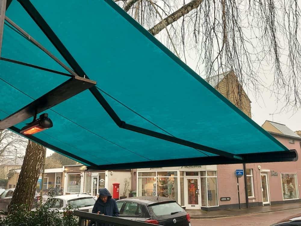 Outdoor dining at El Ricon Restaurant in Oxford with Weinor Opal II design awnings providing shade and comfort to diners.