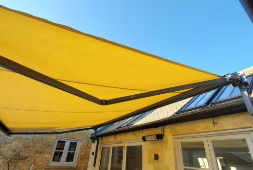 The Markilux 990 waterproof fabric awning in Moreton-In-Marsh, Gloucestershire, keeps you comfortable and dry outdoors with its infrared heater, sensor, and gutter brackets, all while adding style with the Sunvas fabric in 31037 color.