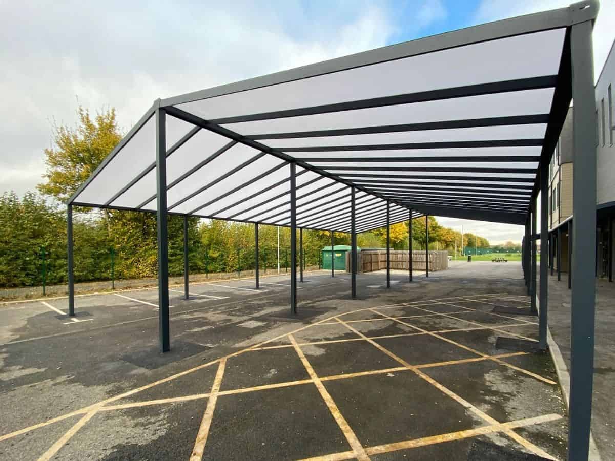 Cotswolds freestanding mono glass roof with pitched roof outside a school