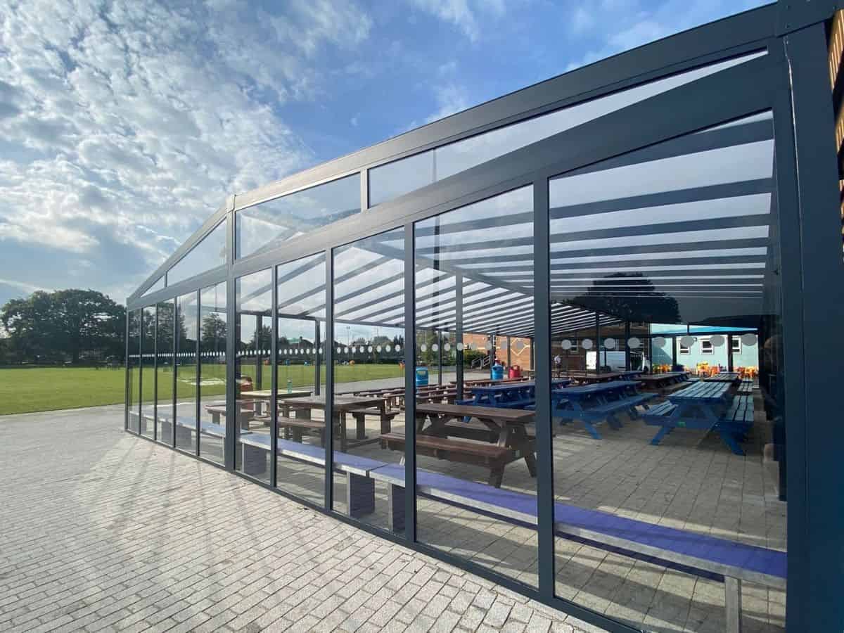 Cotswolds freestanding mono glass roof with pitched roof covering an alfresco cafe area