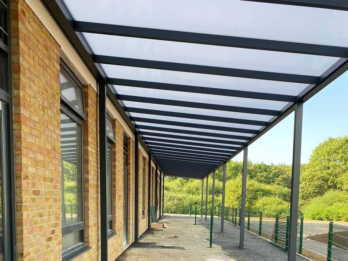 Cotswolds freestanding mono glass roof outdoor sheltered corridor