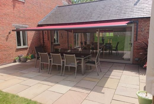 The Weinor Cassita II awning fitted to a house in Leicestershire with bespoke brackets provides a stylish and functional addition to your outdoor living space, with a neat fit underneath eaves on a single storey extension, allowing for an enjoyable and convenient outdoor living experience.