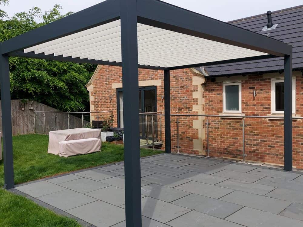 A Tarasola Technic louvred roof freestanding pergola with integrated side zip screens and LED lighting. 3.5m x 4.6m. Installed on a new patio in Bristol