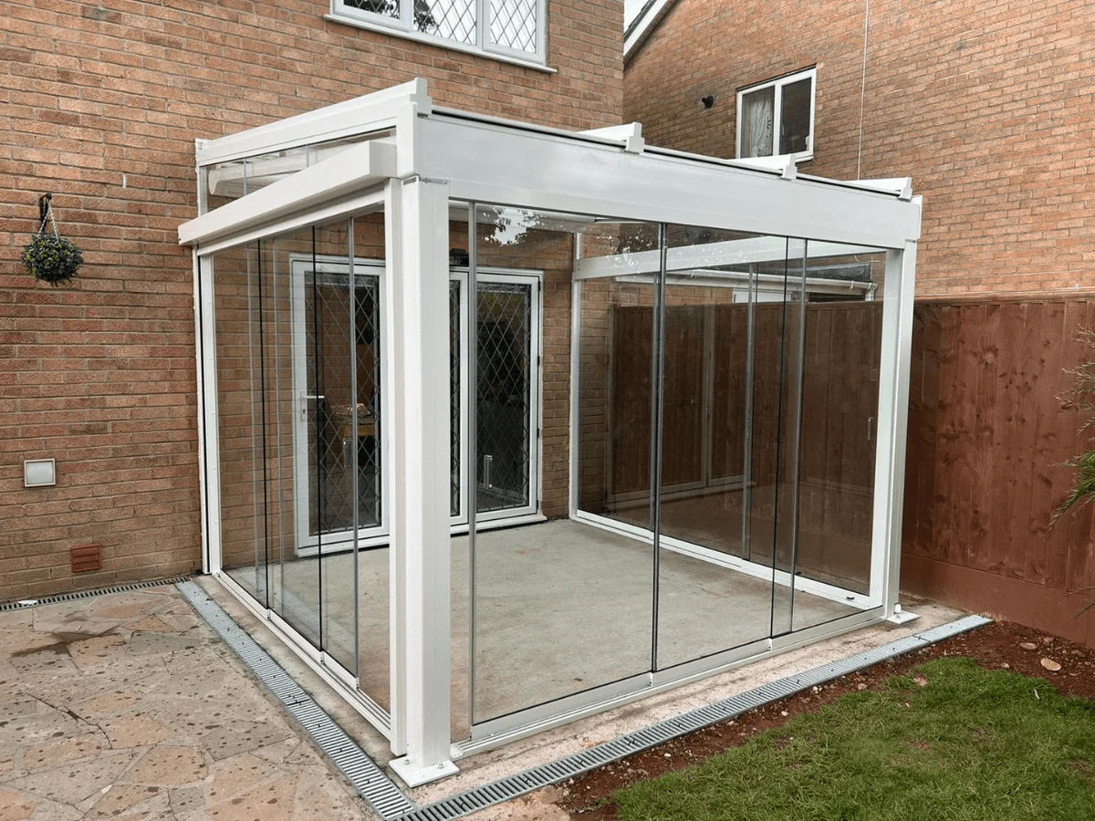 A weinor Terrazza Sempra glass room with sliding doors, with dimmable LED spotlights, underawning and side screen for added privacy - fitted in Bristol