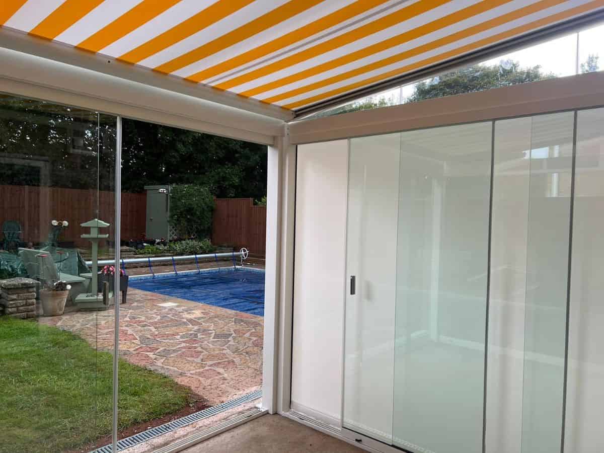 A weinor Terrazza Sempra glass room with sliding doors, and underawning for shade - fitted in Bristol