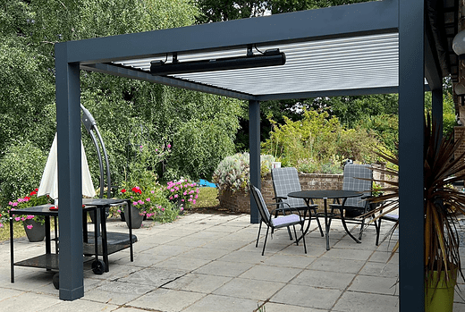 The Seesky Bio louvred roof pergola at a house in Buckinghamshire offers both style and functionality with its gloss finish and integrated LED lights that create a stunning and inviting outdoor living space, perfect for enjoying day and night.