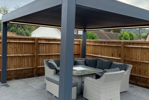 Image of a Deponti Pinela Deluxe retractable louvered roof pergola with dimensions of 4m x 4.128m. The pergola is open, showing the motorized louvers on the roof, with optional glass sides.