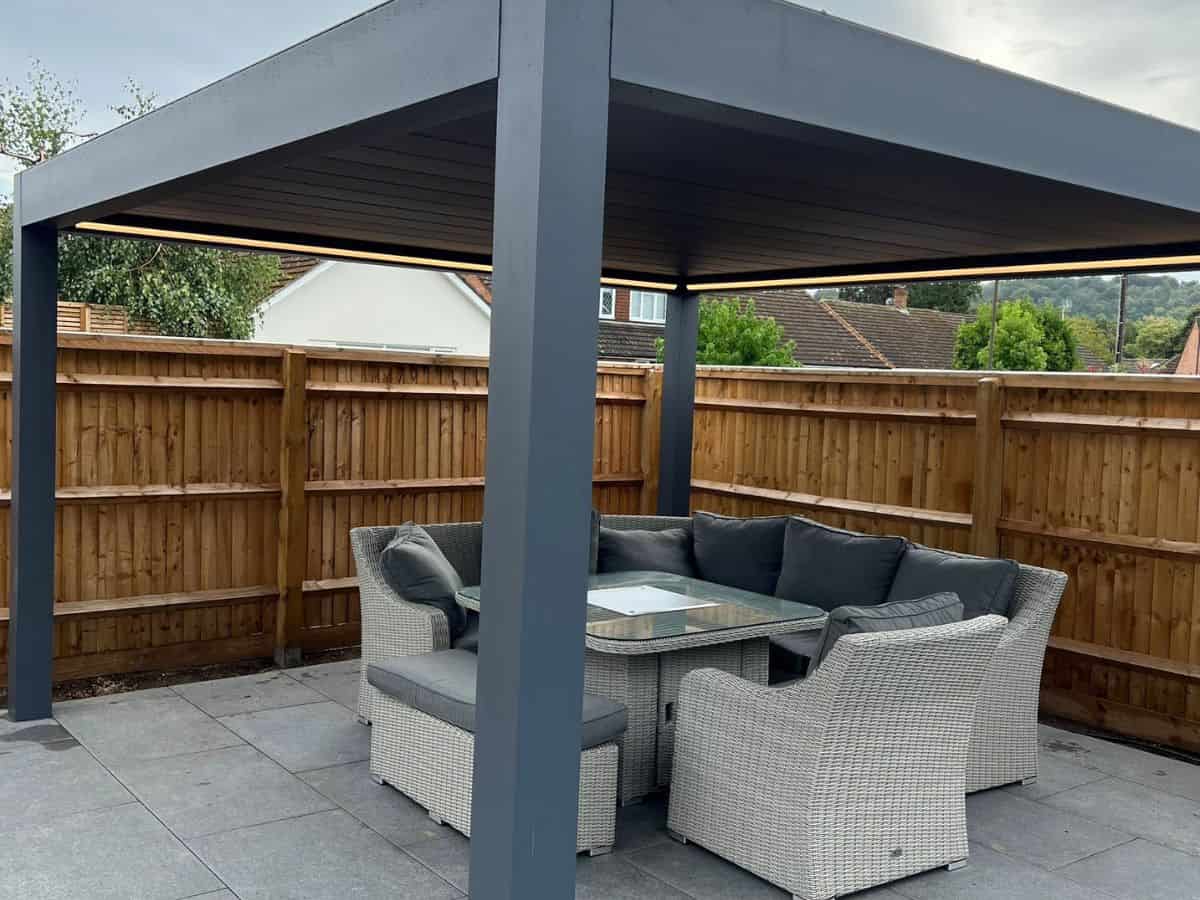 Image of a Deponti Pinela Deluxe retractable louvered roof pergola with dimensions of 4m x 4.128m. The pergola is open, showing the motorized louvers on the roof, with optional glass sides.