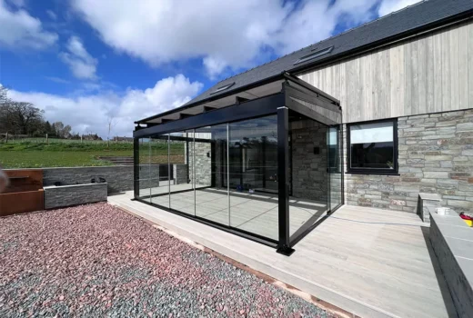 Glass room with over awning for perfect outdoor living space by Cotswold Awnings and Pergolas
