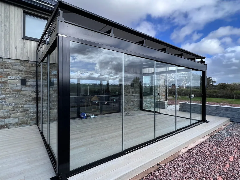 Upgrade your outdoor living space with a glass room and over awning by Cotswold Awnings and Pergolas