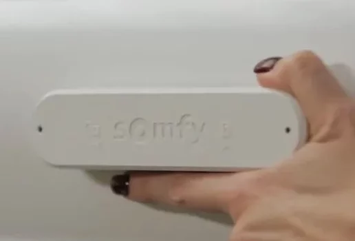 Image of a hand carefully removing the casing of a Somfy wind sensor