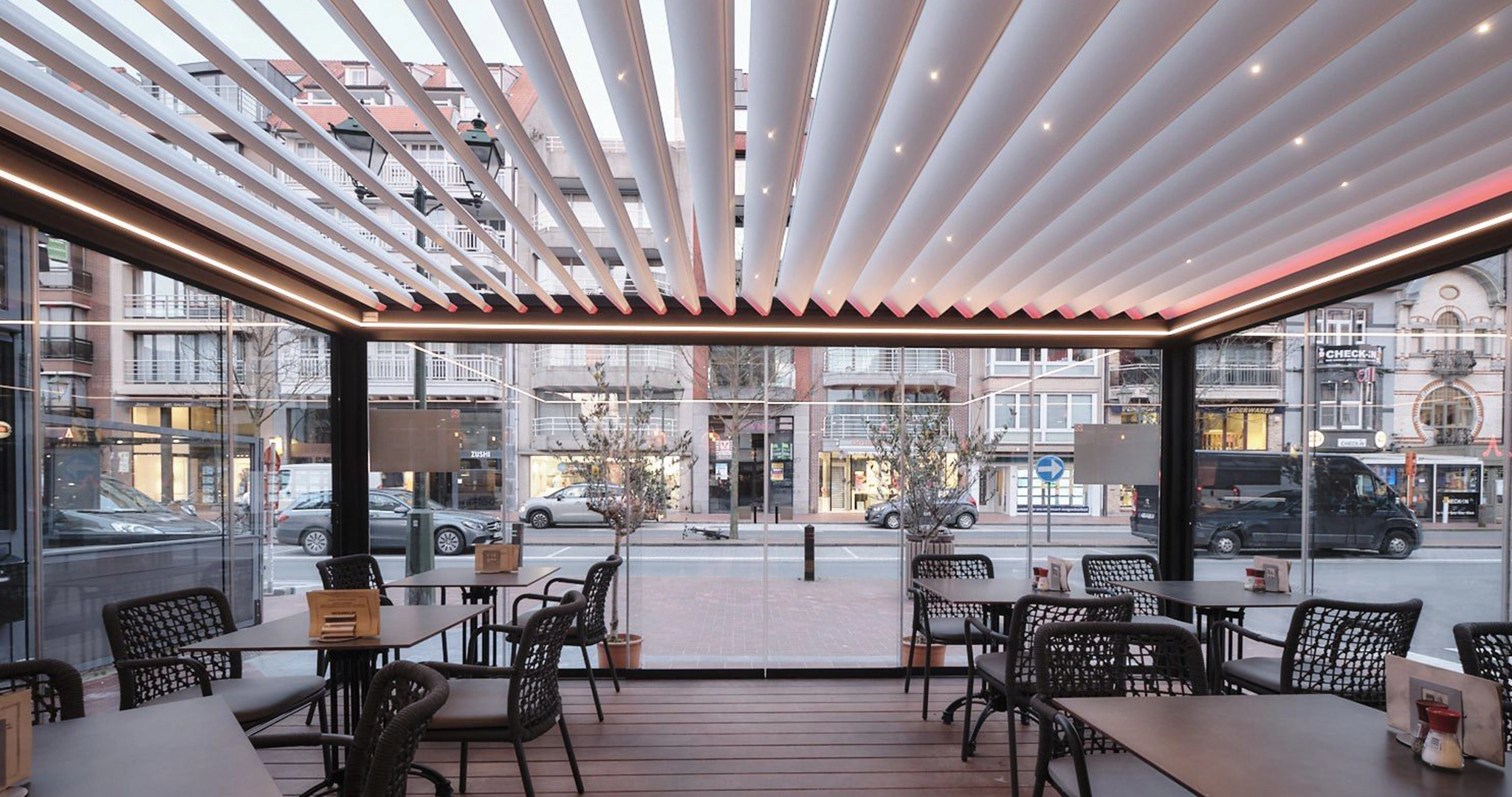 Louvred roof pergola with LED lighting adorning the front of a high-street cafe.